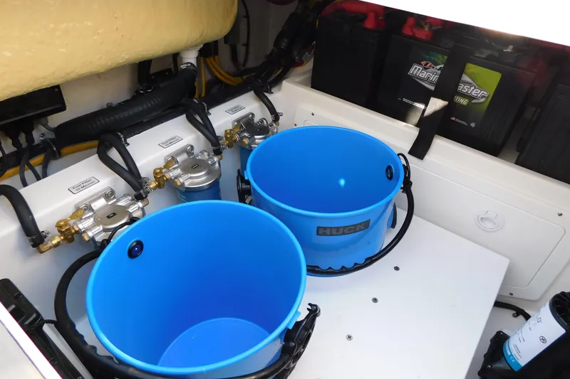 Slide: The Image of Engine compartment of 2026 Regulator 35 with blue buckets and Marine Master batteries. - 33