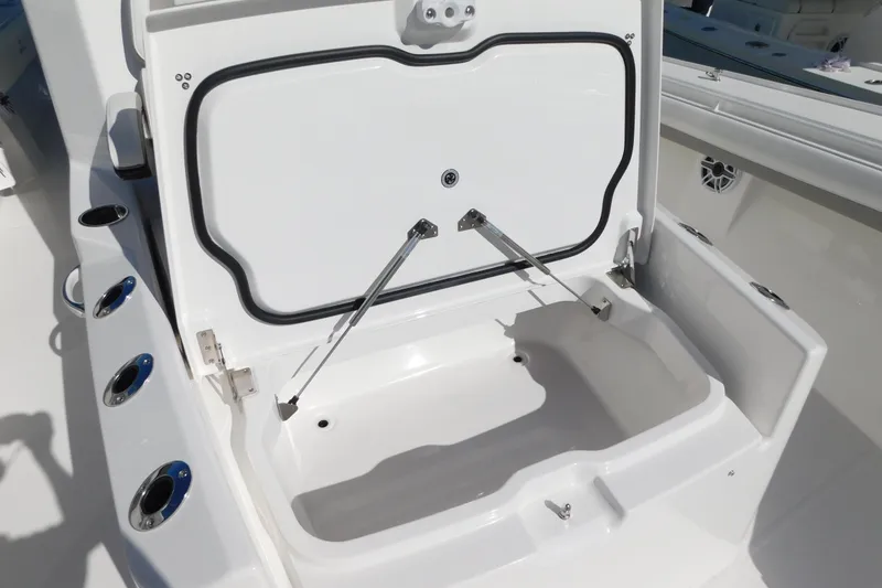 Slide: The Image of Open storage compartment on a 2026 Regulator 35 boat, featuring multiple rod holders. - 48