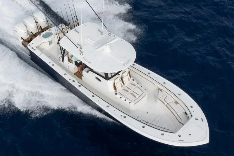 Slide: The Image of Manufacturer Provided Image: 2026 Regulator 35 boat cruising on open water, equipped with multiple fishing rods. - 5