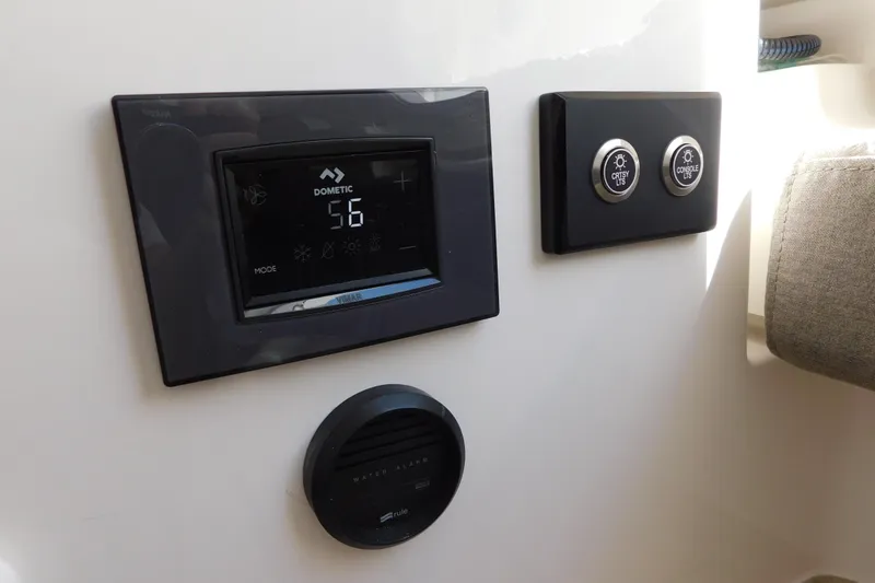 Slide: The Image of Control panel on 2026 Regulator 35 boat with Dometic display and light switches. - 56