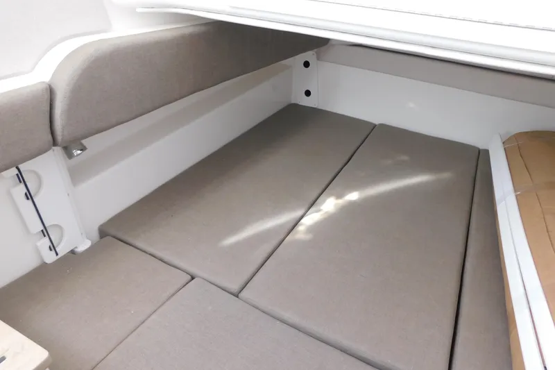 Slide: The Image of 2026 Regulator 35 boat interior with cushioned seating and storage area. - 65