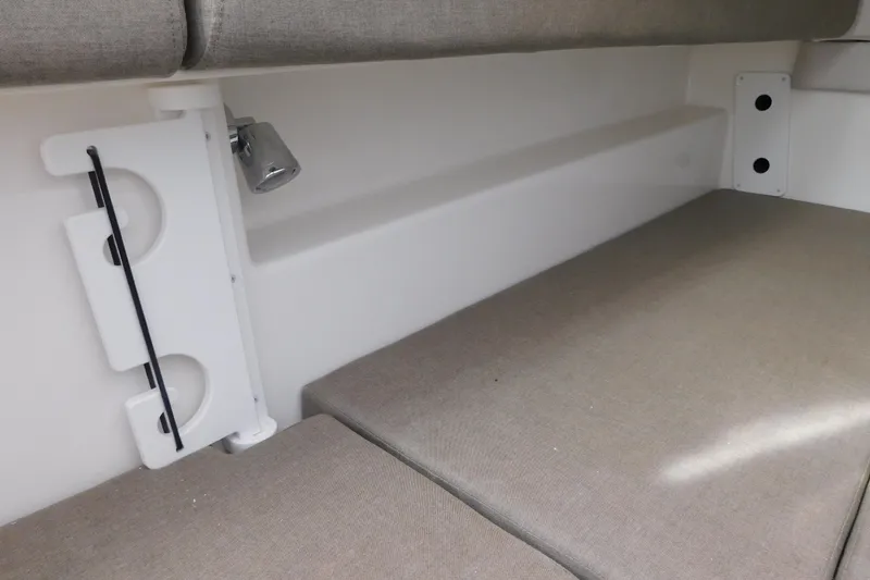 Slide: The Image of Interior view of 2026 Regulator 35 boat with beige seating and wall-mounted light. - 66