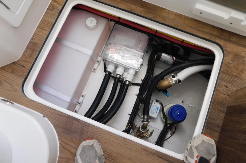 Slide: The Image of Electrical and plumbing components inside a 2026 Regulator 35 boat compartment. - 68