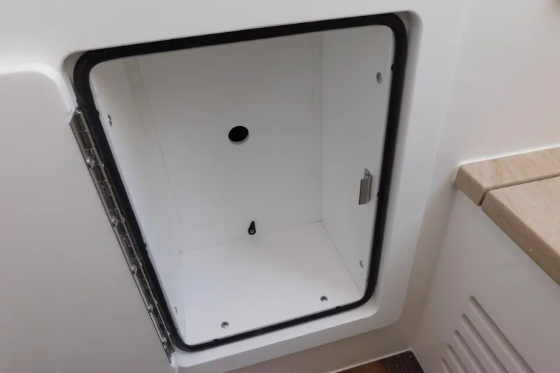 Slide: The Image of Open storage compartment on 2026 Regulator 35 boat, featuring a clean, white interior. - 70