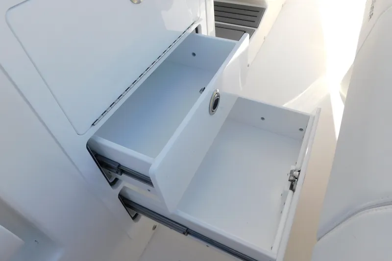 Slide: The Image of Open storage drawers on a 2026 Regulator 35 boat, showcasing sleek design and functionality. - 75