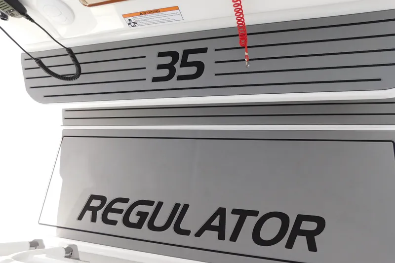 Slide: The Image of 2026 Regulator 35 boat interior with branding and safety warning. - 86