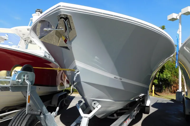 Slide: The Image of 2026 Regulator 35 boat on trailer, displayed outdoors under clear blue sky. - 96