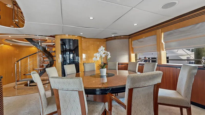 Slide: The Image of Luxurious dining area on 2005 New Zealand Yachts Wave Piercer with elegant decor and spiral staircase. - 25