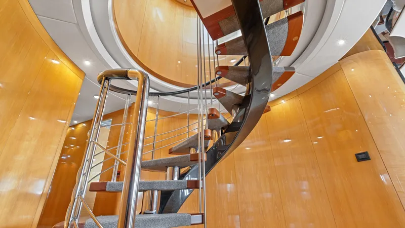 Slide: The Image of Spiral staircase inside 2005 New Zealand Yachts Wave Piercer, featuring sleek wooden and metal design. - 27