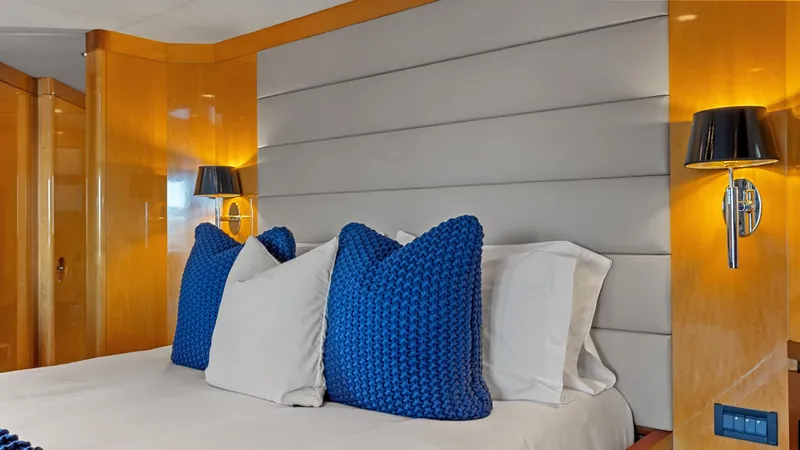 Slide: The Image of Luxurious yacht bedroom with blue pillows, modern lighting, and wooden accents, New Zealand Yachts Wave Piercer 2005. - 30