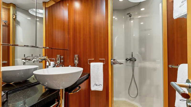 Slide: The Image of Luxurious yacht bathroom with modern fixtures, wooden accents, and a sleek shower. - 43
