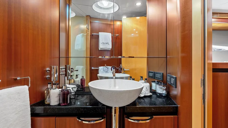 Slide: The Image of Luxurious yacht bathroom with modern sink, wooden cabinetry, and elegant fixtures on a 2005 New Zealand Yachts Wave Piercer. - 48