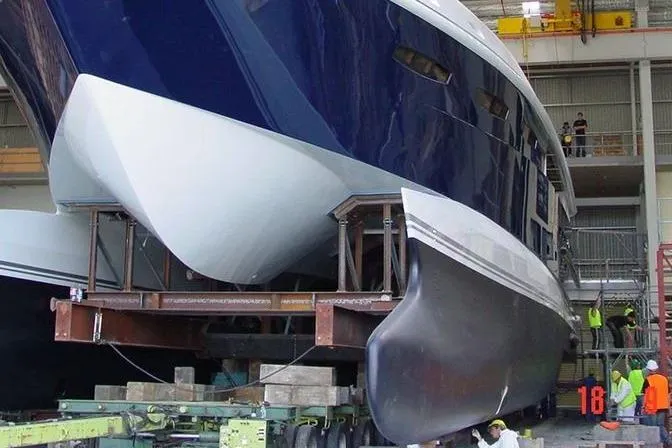 Slide: The Image of 2005 New Zealand Yachts Wave Piercer in shipyard, showcasing sleek hull design. - 61