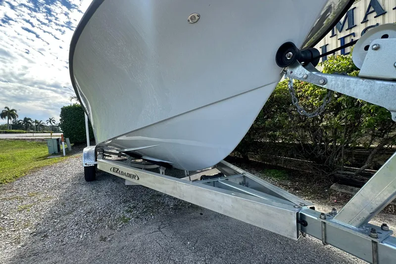 Slide: The Image of 2026 Delta Boatworks Delta D245 on EZ Loader trailer, parked outdoors. - 21