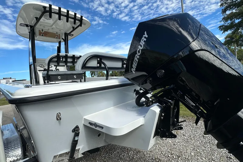 Slide: The Image of 2026 Delta Boatworks Delta D245 with Mercury outboard motor, parked on gravel under blue sky. - 3