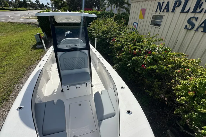 Slide: The Image of 2026 Delta Boatworks Delta D245, sleek design, parked near Naples Sail building. - 6