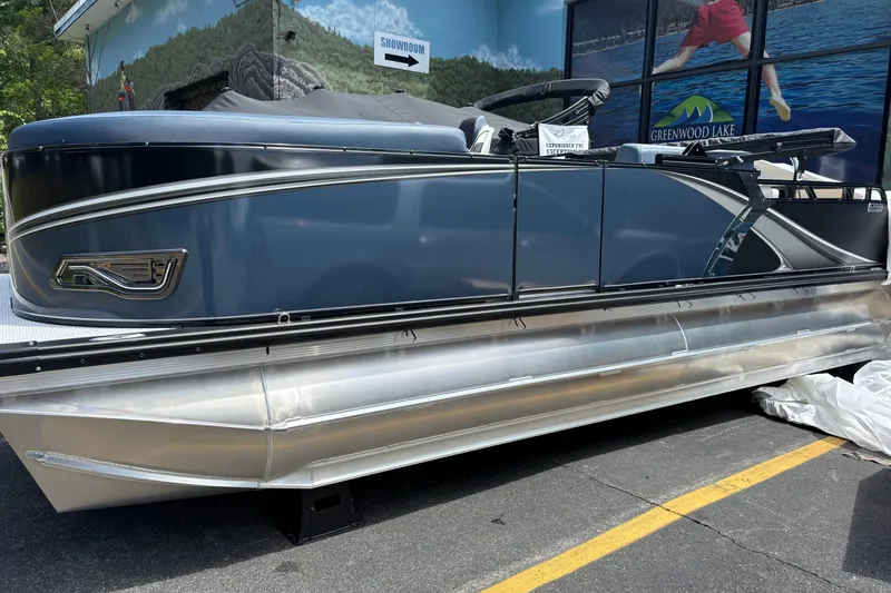 The Image of 2026 Avalon LSZ ELITE pontoon boat displayed outdoors near showroom. - 0