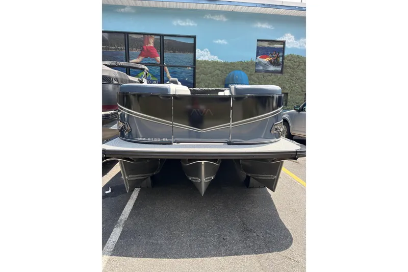 Slide: The Image of 2026 Avalon LSZ ELITE pontoon boat, rear view, parked outdoors. - 10