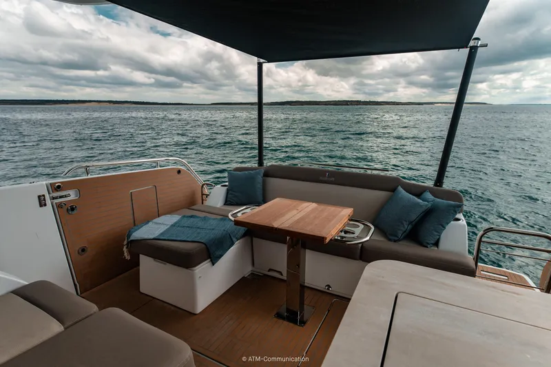Slide: The Image of Luxurious 2026 Wellcraft 44 Explorer yacht deck with seating, table, and ocean view. - 10