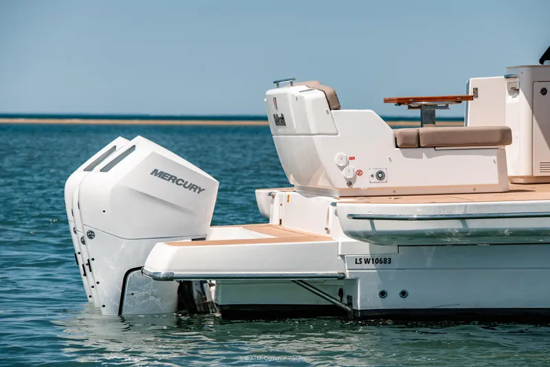 Slide: The Image of 2026 Wellcraft 44 Explorer boat with Mercury outboard engine on calm water. - 20