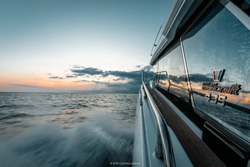 Slide: The Image of 2026 Wellcraft 44 Explorer cruising at sunset on open water. - 24