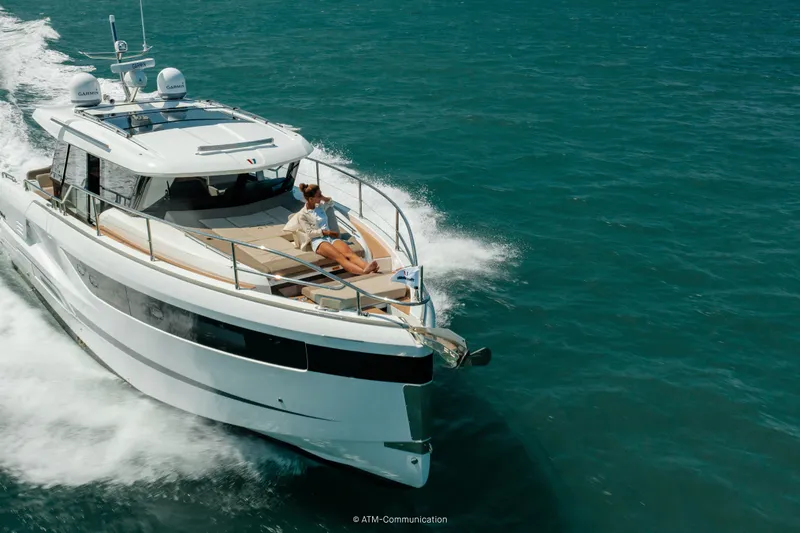 Slide: The Image of 2026 Wellcraft 44 Explorer yacht cruising on open water with passenger relaxing on deck. - 3