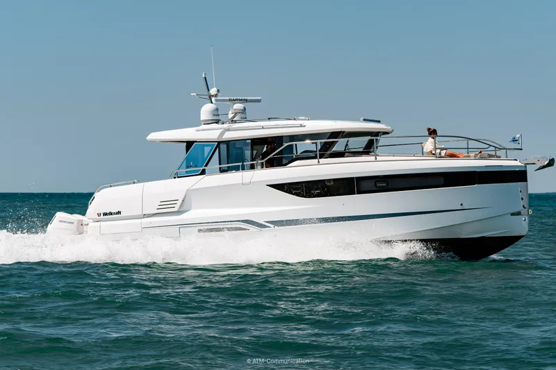 Slide: The Image of 2026 Wellcraft 44 Explorer yacht cruising on open water. - 5