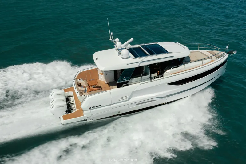 Slide: The Image of 2026 Wellcraft 44 Explorer yacht cruising on open water, showcasing sleek design and powerful engines. - 6