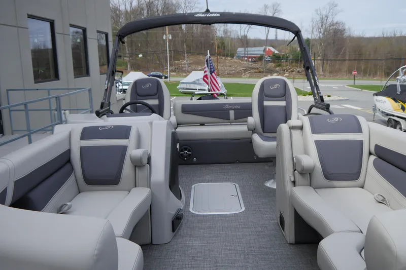 Slide: The Image of 2025 Barletta Cabrio 22UC pontoon boat interior with plush seating and modern design. - 11