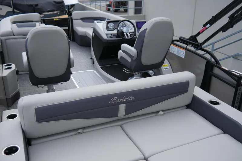 Slide: The Image of 2025 Barletta Cabrio 22UC pontoon boat interior with plush seating and modern dashboard. - 13