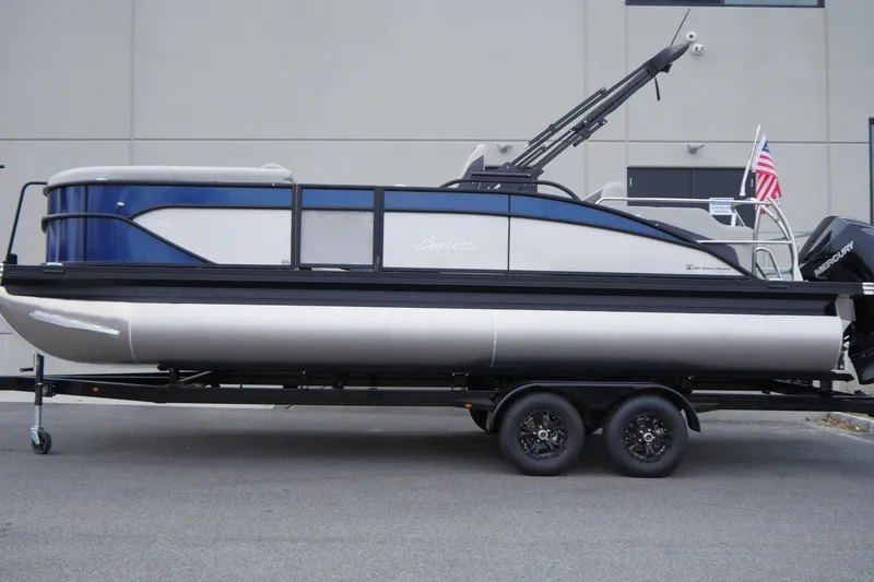 Slide: The Image of 2025 Barletta Cabrio 22UC pontoon boat on trailer, side view, with American flag. - 3