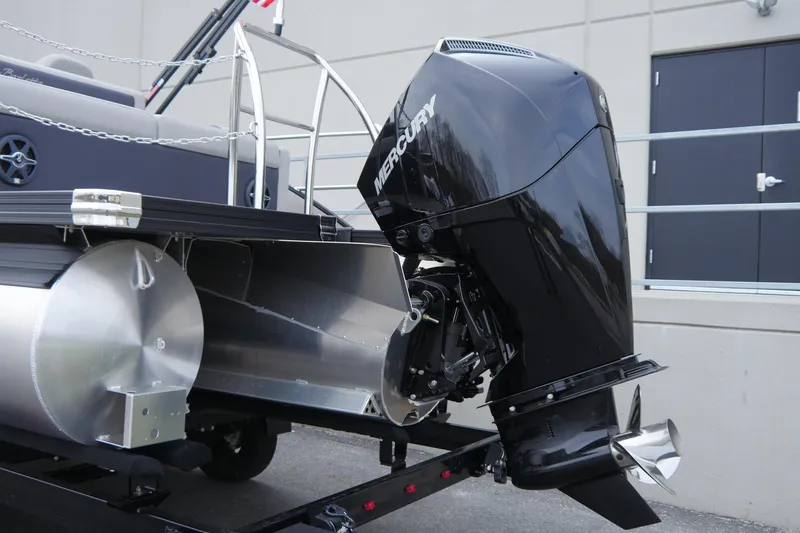 Slide: The Image of 2025 Barletta Cabrio 22UC pontoon boat with Mercury outboard motor, side view. - 4