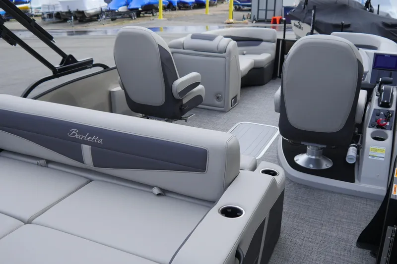 Slide: The Image of 2025 Barletta Cabrio 22UC pontoon boat interior with gray seating and modern design. - 6