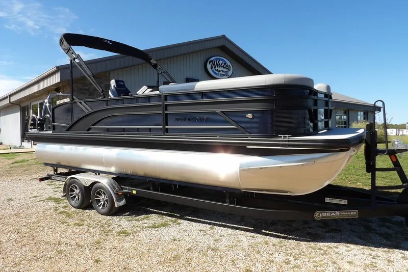 The Image of 2026 Bennington S Swingback 22 SSB pontoon boat on trailer, parked outdoors. - 1