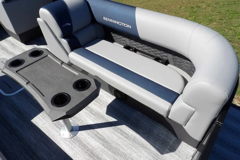 Slide: The Image of 2026 Bennington S Swingback 22 SSB boat interior with cushioned seating and cup holders. - 12