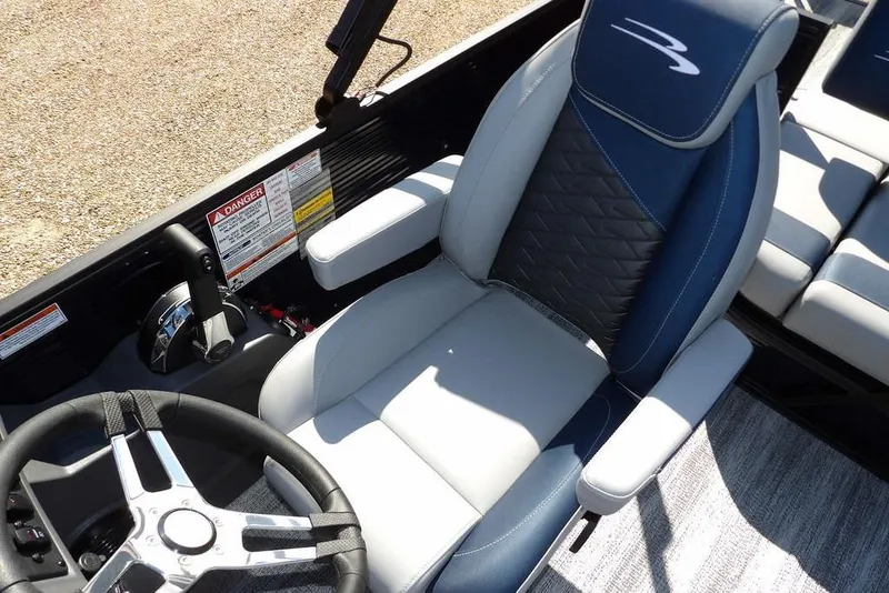 Slide: The Image of 2026 Bennington S Swingback 22 SSB boat interior with steering wheel and luxurious seating. - 18