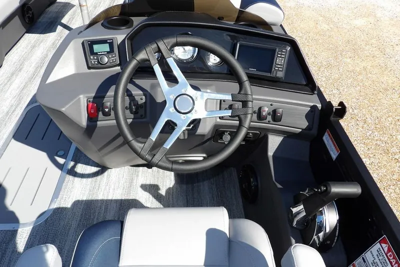 Slide: The Image of 2026 Bennington S Swingback 22 SSB boat dashboard with steering wheel and controls. - 21