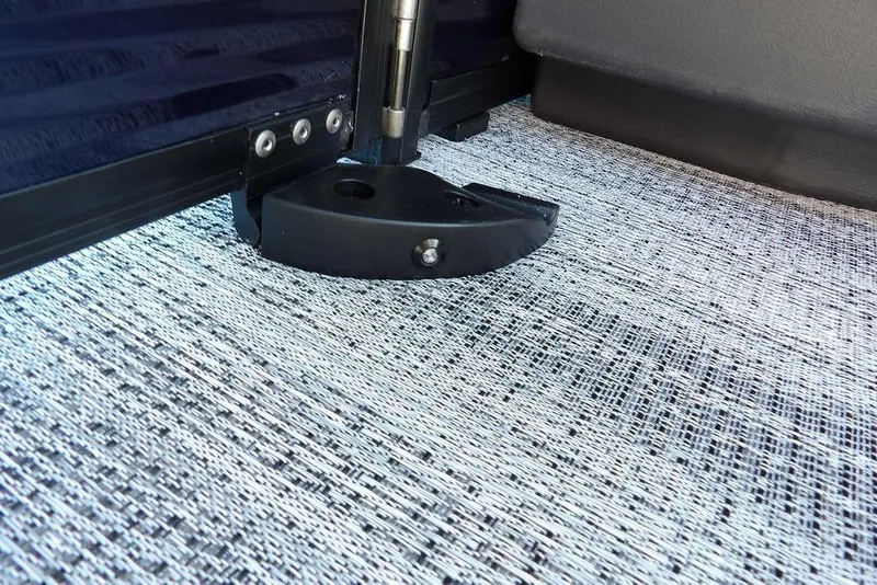 Slide: The Image of 2026 Bennington S Swingback 22 SSB interior detail with textured flooring and hinge mechanism. - 26