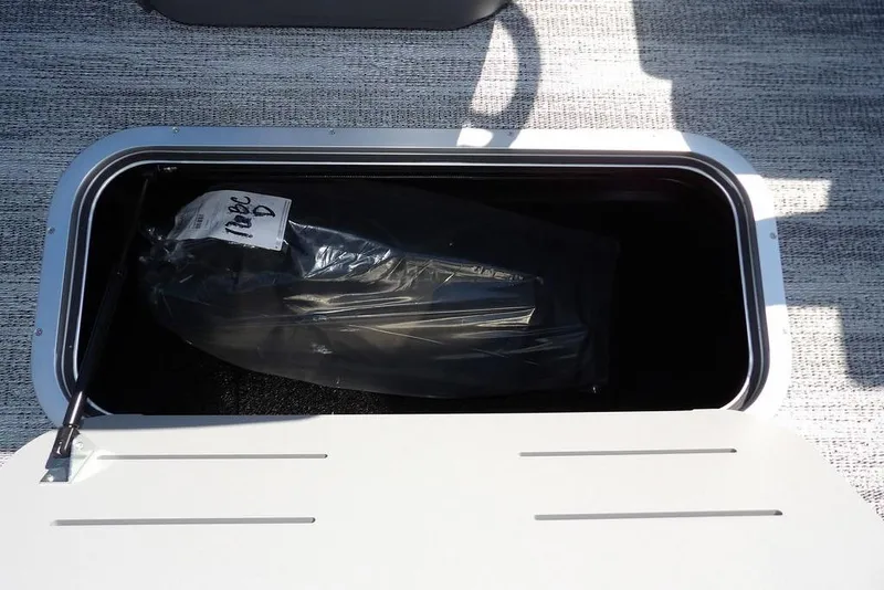 Slide: The Image of Storage compartment of 2026 Bennington S Swingback 22 SSB boat, open with contents inside. - 34