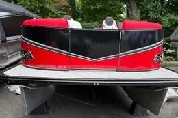 Slide: The Image of 2025 Avalon LSZ Quad Lounger Shift pontoon boat with red and black design. - 2