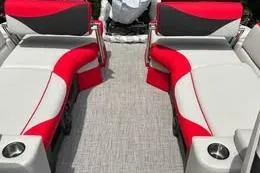 Slide: The Image of 2025 Avalon LSZ Quad Lounger Shift boat interior with red and gray seating. - 3
