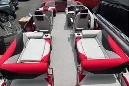 Slide: The Image of 2025 Avalon LSZ Quad Lounger Shift boat interior with red and gray seating. - 5