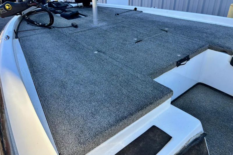 Slide: The Image of 2012 Skeeter TZX190 boat deck with gray carpet and storage compartments. - 5