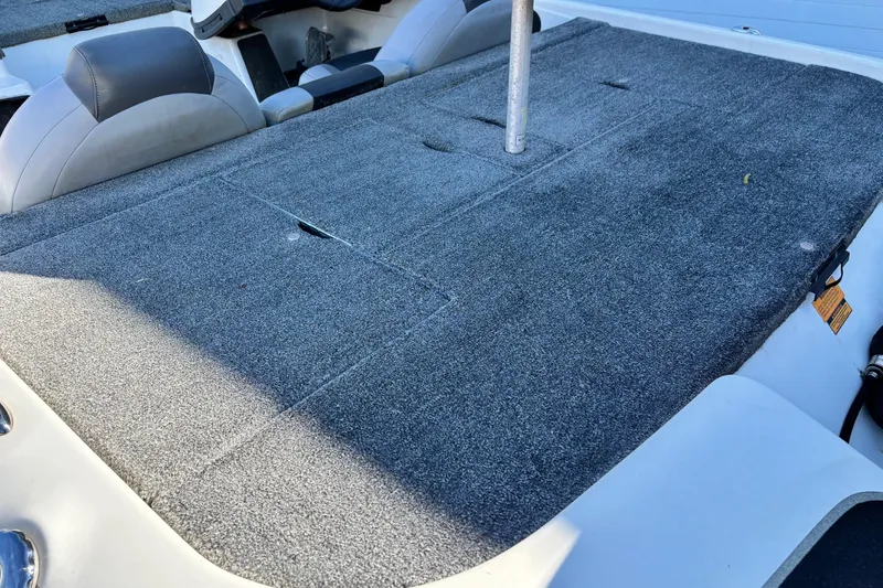 Slide: The Image of 2012 Skeeter TZX190 boat interior with gray carpeted deck and seating. - 9