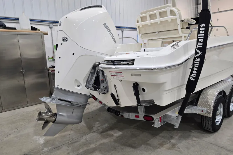Slide: The Image of 2026 Boston Whaler 220 Dauntless boat on trailer in garage setting. - 17
