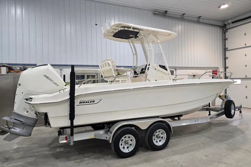 Slide: The Image of 2026 Boston Whaler 220 Dauntless boat on trailer in indoor storage. - 18
