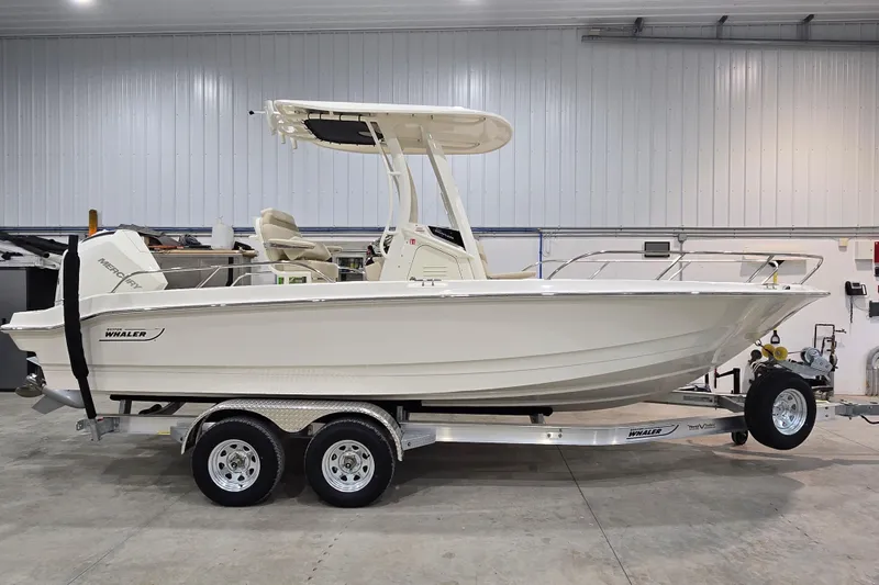 Slide: The Image of 2026 Boston Whaler 220 Dauntless boat on trailer in indoor storage. - 19