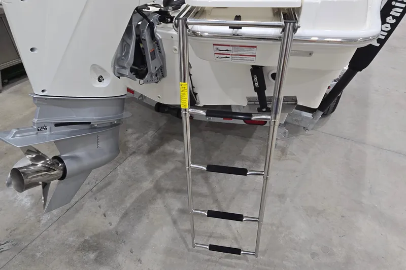 Slide: The Image of 2026 Boston Whaler 220 Dauntless boat with ladder and outboard motor detail. - 21