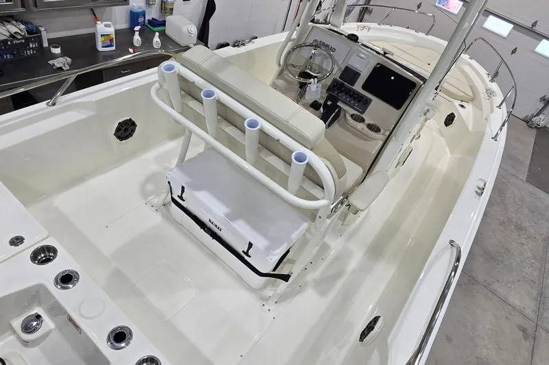 Slide: The Image of 2026 Boston Whaler 220 Dauntless boat interior with helm, seating, and rod holders. - 23