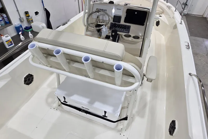 Slide: The Image of 2026 Boston Whaler 220 Dauntless boat interior with rod holders and steering console. - 24